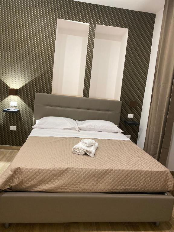 a bedroom with a bed with a towel on it at Maison Caravita in Naples