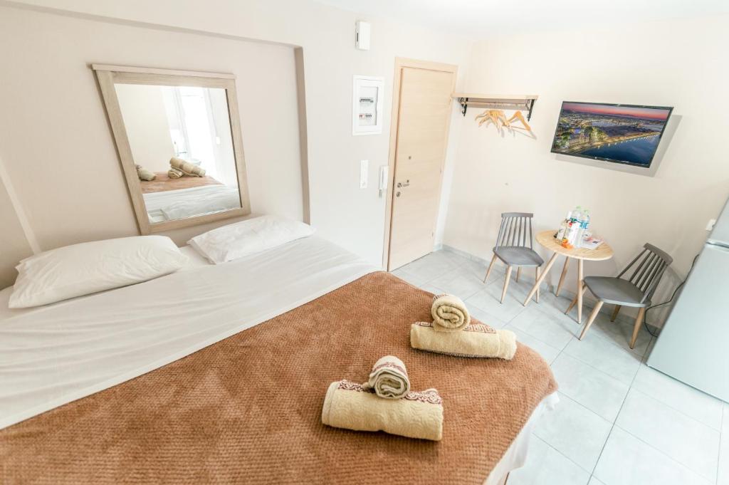 a bedroom with a bed with two towels on it at Old Town Euphoria Suite in Kos