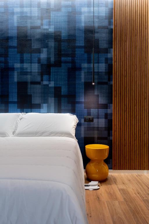 a bedroom with a bed and a blue wall at CALVANI23 LUXURY HOUSE in Bari