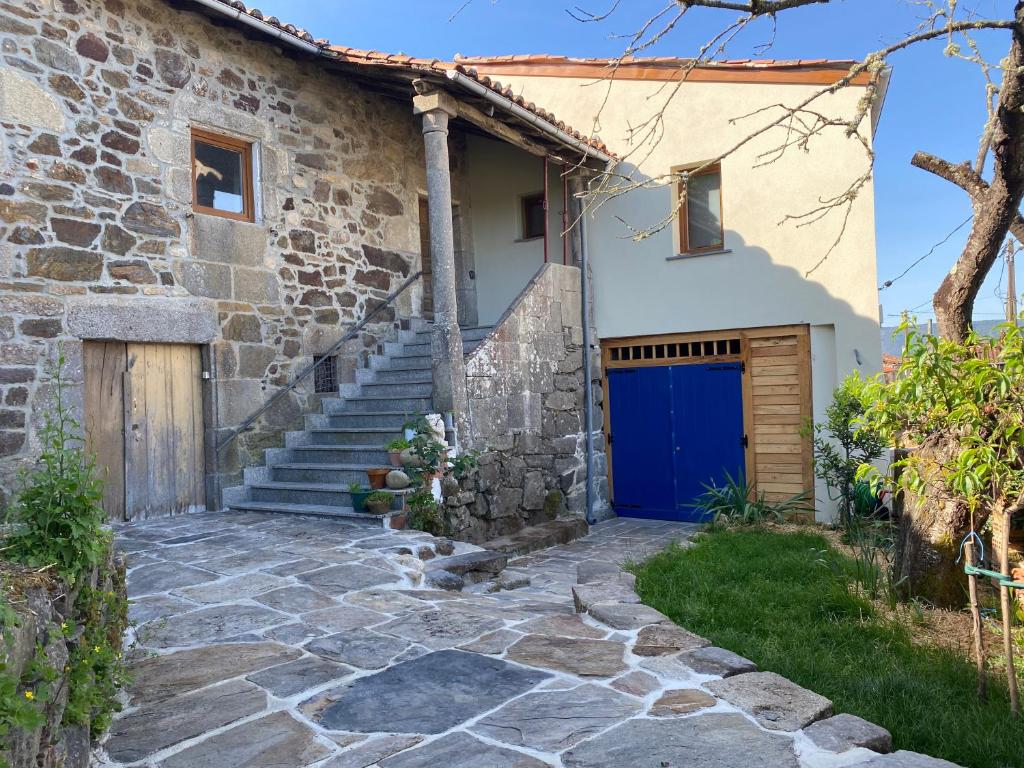 una casa con garage blu e scale di Farm house in Ribeira Sacra a O Carballo