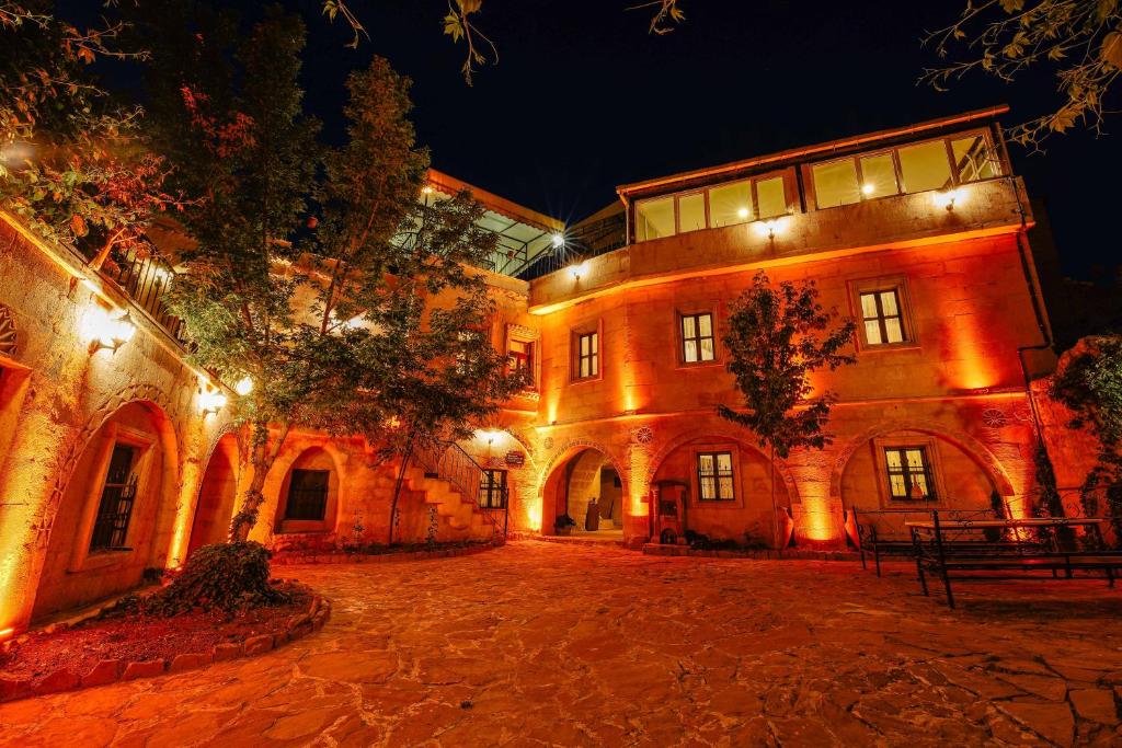 a large building with lights on it at night at Alaca Cave Suites in Goreme