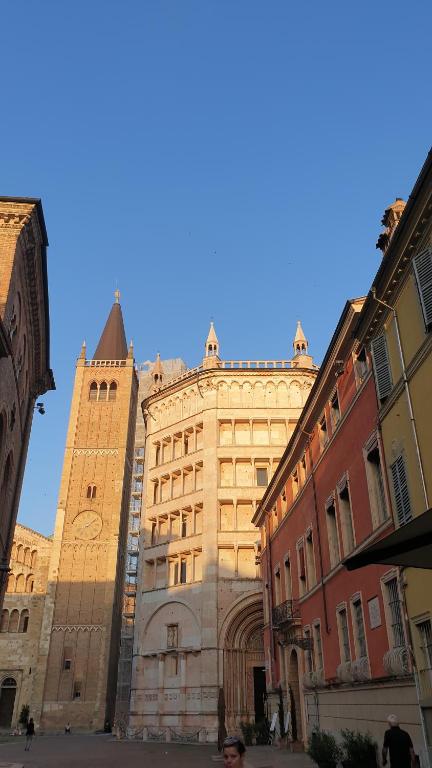 a large building with a clock tower in a city at Mansarda Laurent in Parma