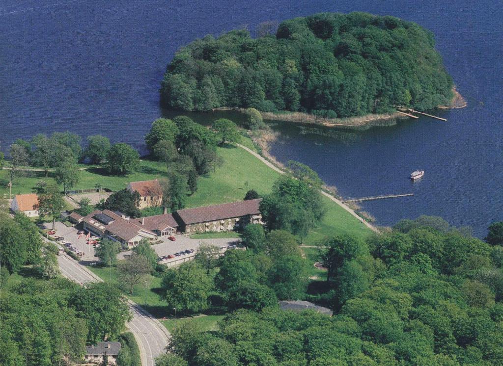 an aerial view of a house on an island in the water at Hotel Skanderborghus in Skanderborg