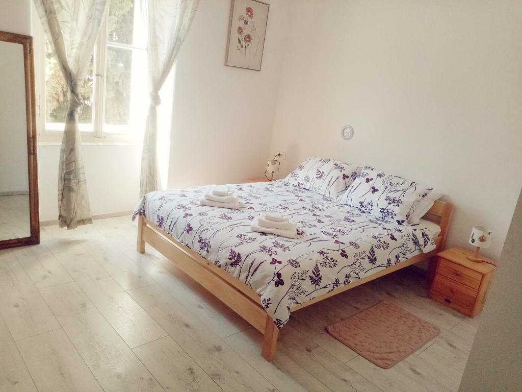 a bedroom with a bed in a room with a window at San Eleuterio Guesthouse in Poreč