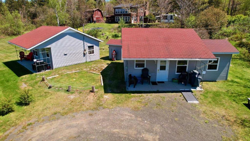 an aerial view of a small house with a red roof at Stargazers Cove Cottages Otter in Middleton