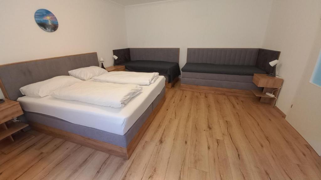 a small bedroom with a bed and a chair at Chill & Relax Apartments Purbach in Purbach am Neusiedlersee