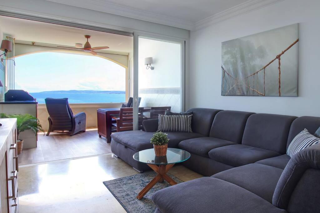 a living room with a couch and a table at Marina Bay by Asola Property in Estepona