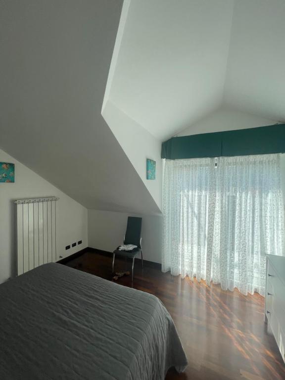a bedroom with a bed and a large window at Sunnyhouse in Santa Margherita Ligure
