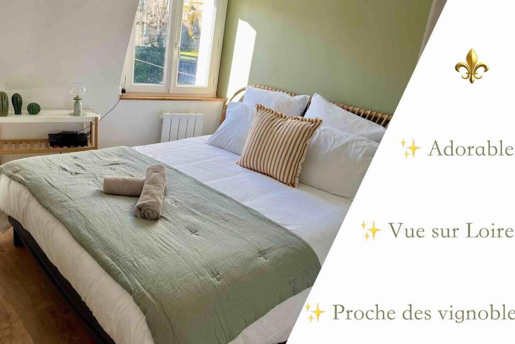 a bedroom with a bed with two towels on it at Rochecorbon - Bouchon de Loire in Rochecorbon