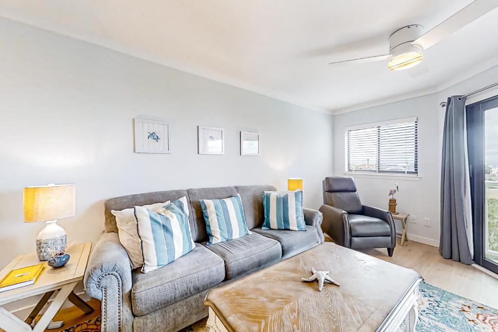 a living room with a couch and a table at Bay Creek Villa - 304 in Edisto Island