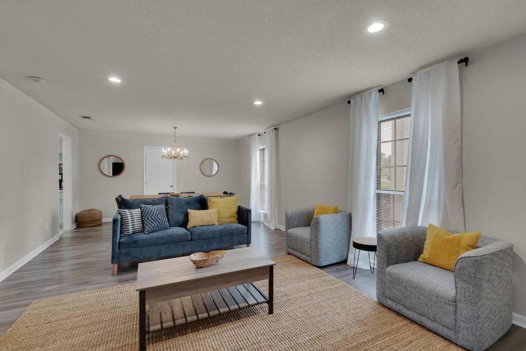 sala de estar con sofá azul y 2 sillas en Quiet relaxing home - Close to Downtown & Beach 4BR-2BT en Pensacola