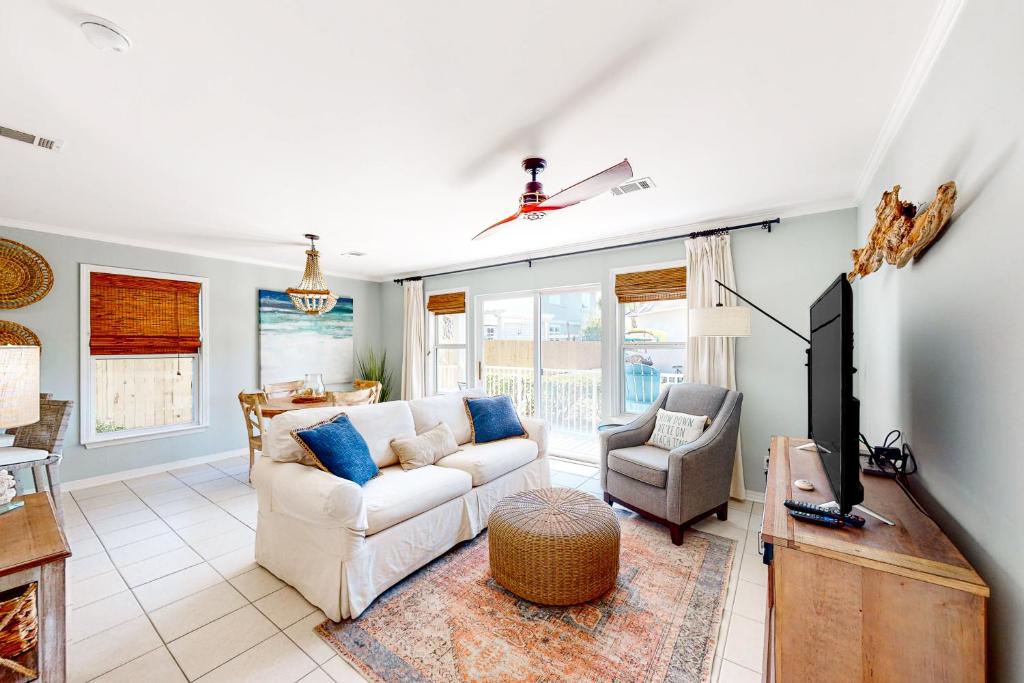 a living room with a couch and a tv at Sugar Sand Oasis in Santa Rosa Beach