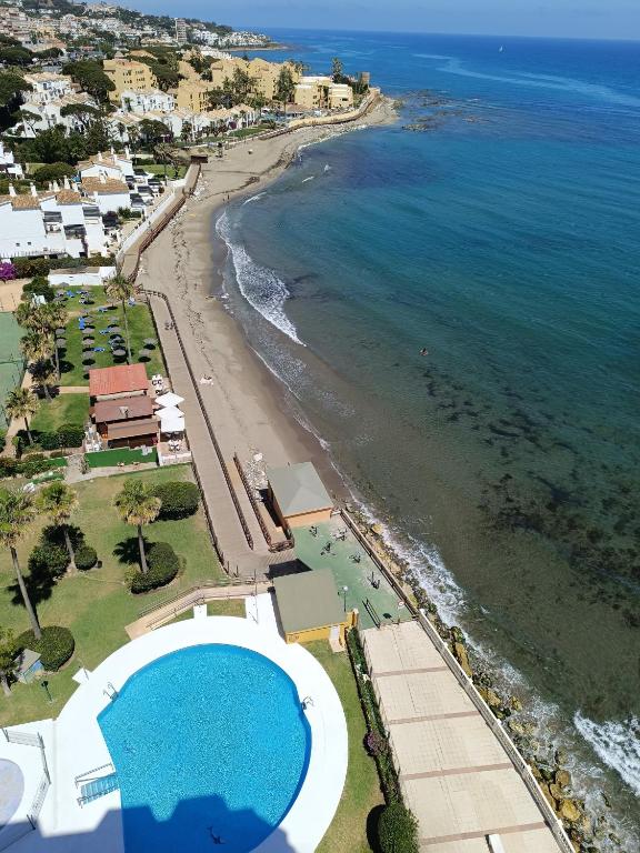 an aerial view of a beach with a swimming pool at BEACH ALMIRANTE 9 MIJAS Marbella in Sitio de Calahonda