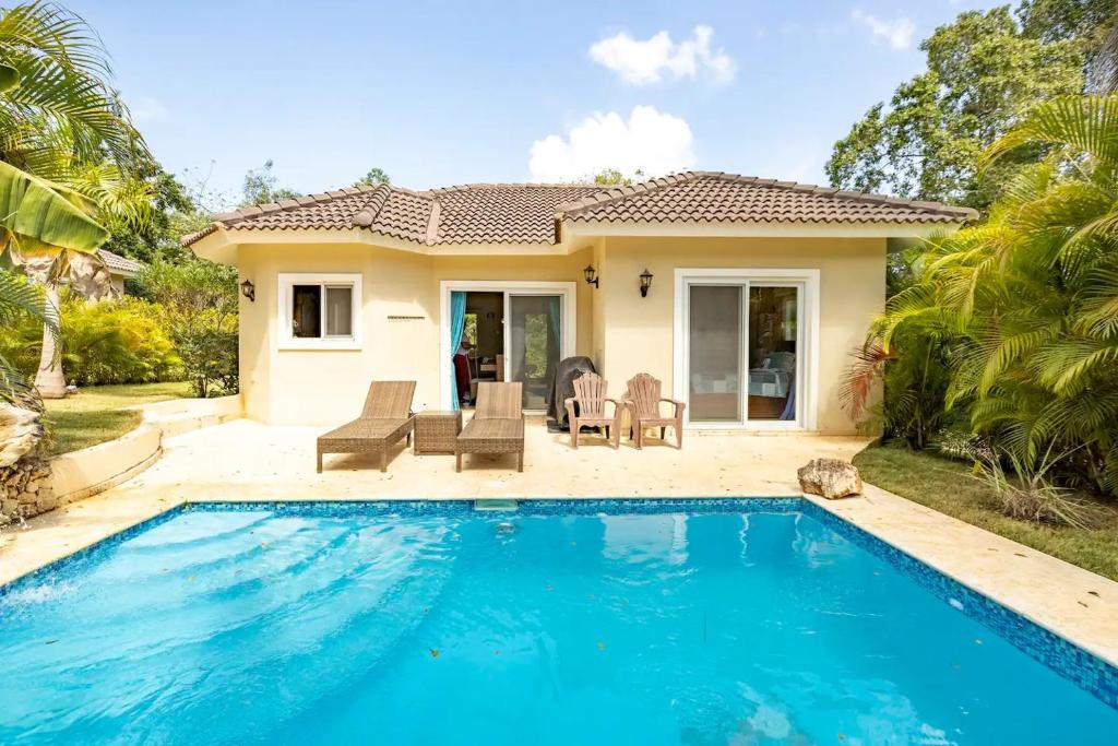 a villa with a swimming pool in front of a house at 2 Bed, 2 Bath, New Jacuzzi, High Speed Wi-Fi in Sosúa