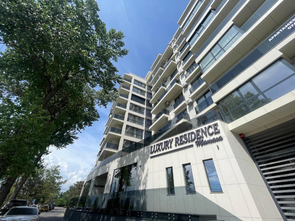 a building with a sign on the side of it at LUXURY Residence 2 bed-room Apartment in Mamaia