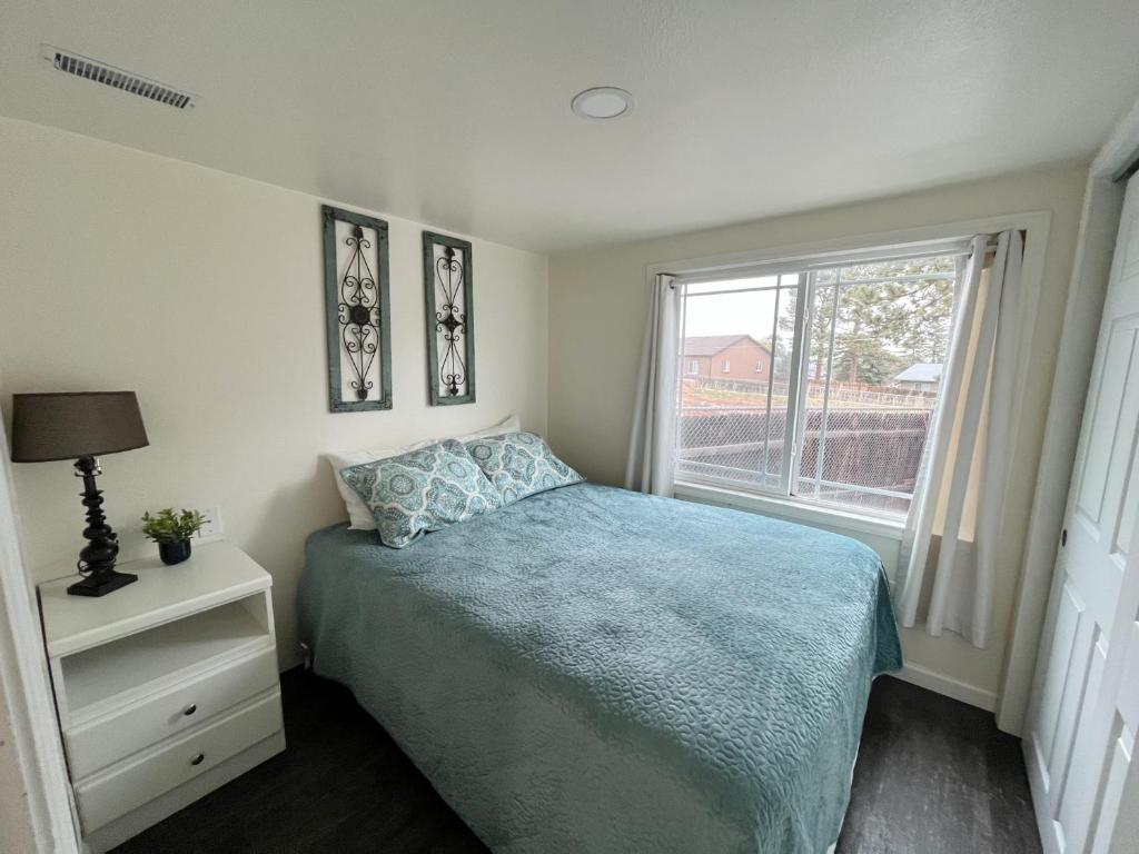 a small bedroom with a bed and a window at Pinon in Woodland Park