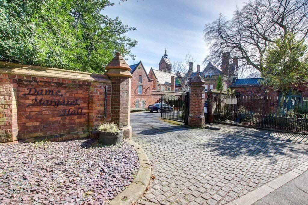 a brick fence with a gate in front of a house at Washington Village Apartment in Washington