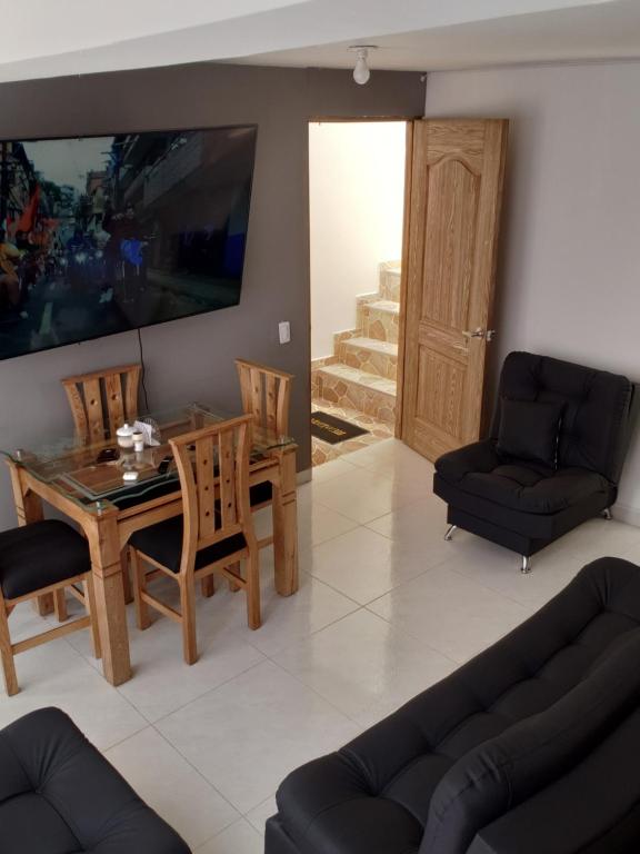 a living room with a dining room table and chairs at Moderno y Amplio Apartamento in Medellín