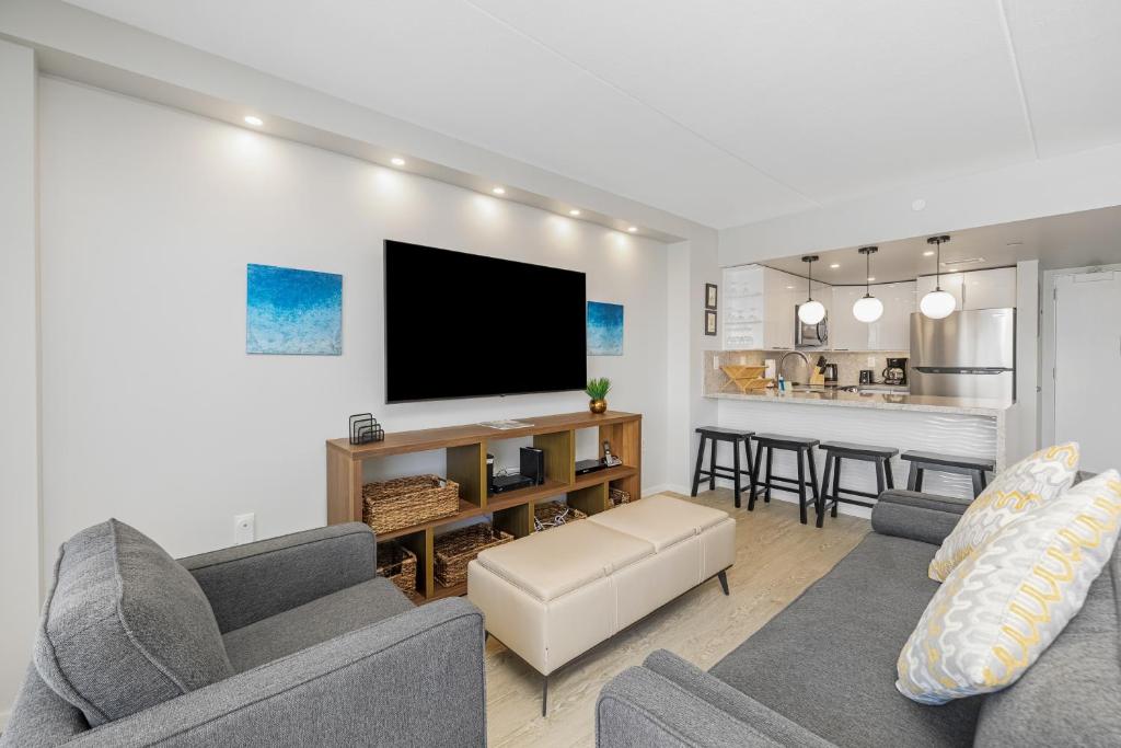 a living room with a couch and a tv at Marina Views Studio - Ilikai, 941 in Honolulu