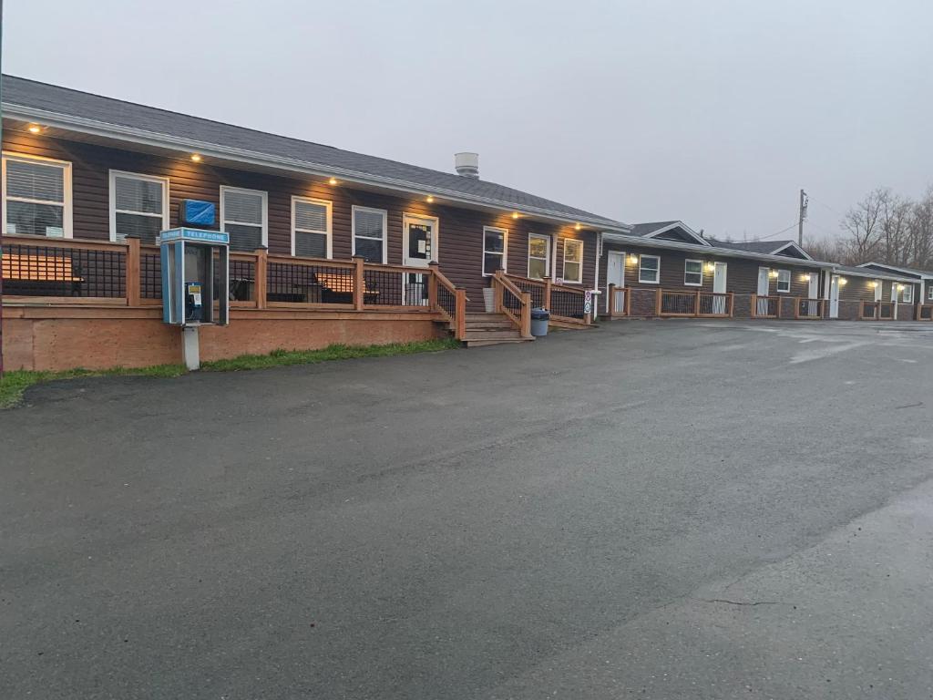 a parking lot in front of a building at Legges Motel & Restaurant in Heartʼs Content