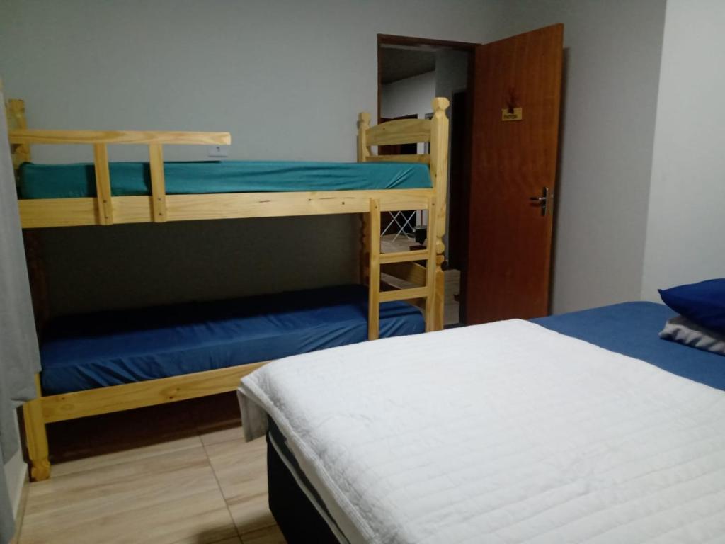 a bedroom with two bunk beds and a closet at Em Busca Hostel in Bonito