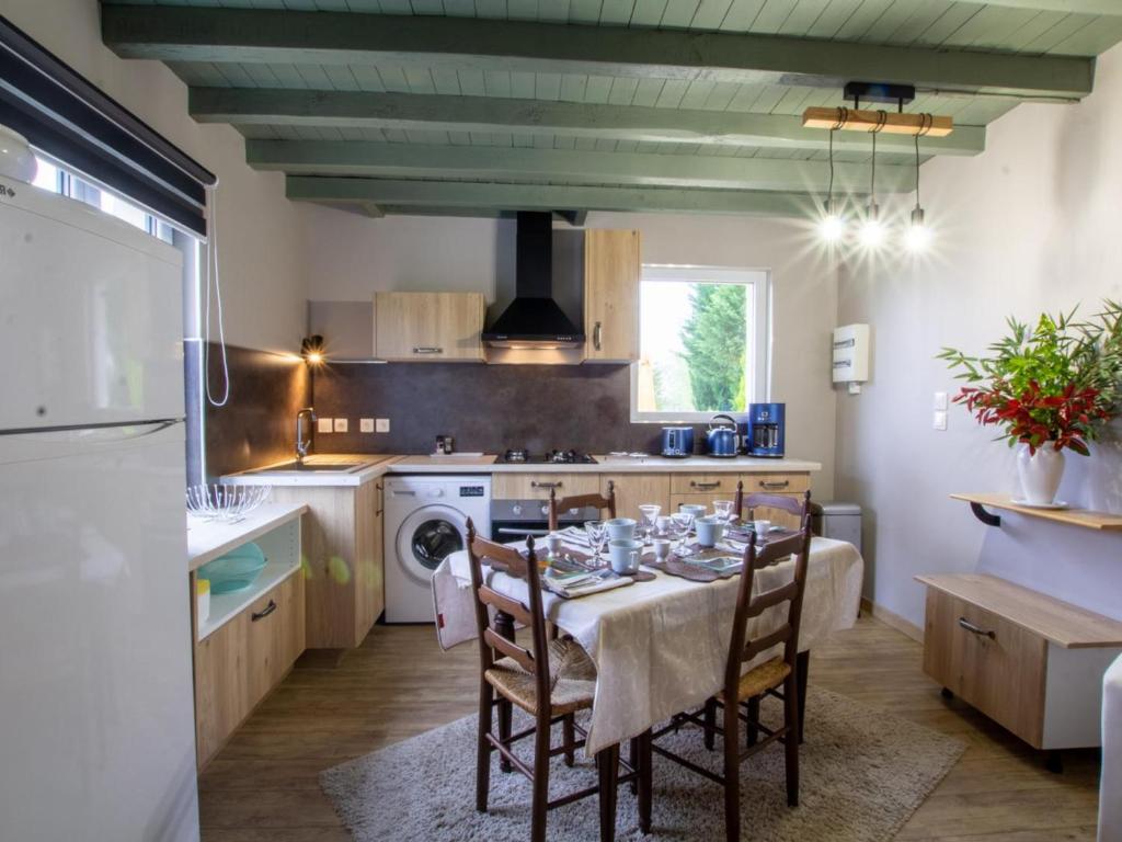 a kitchen with a table and chairs in a room at Gîte Saint-Michel-de-Double, 3 pièces, 4 personnes - FR-1-616-308 in Saint-Michel-de-Double