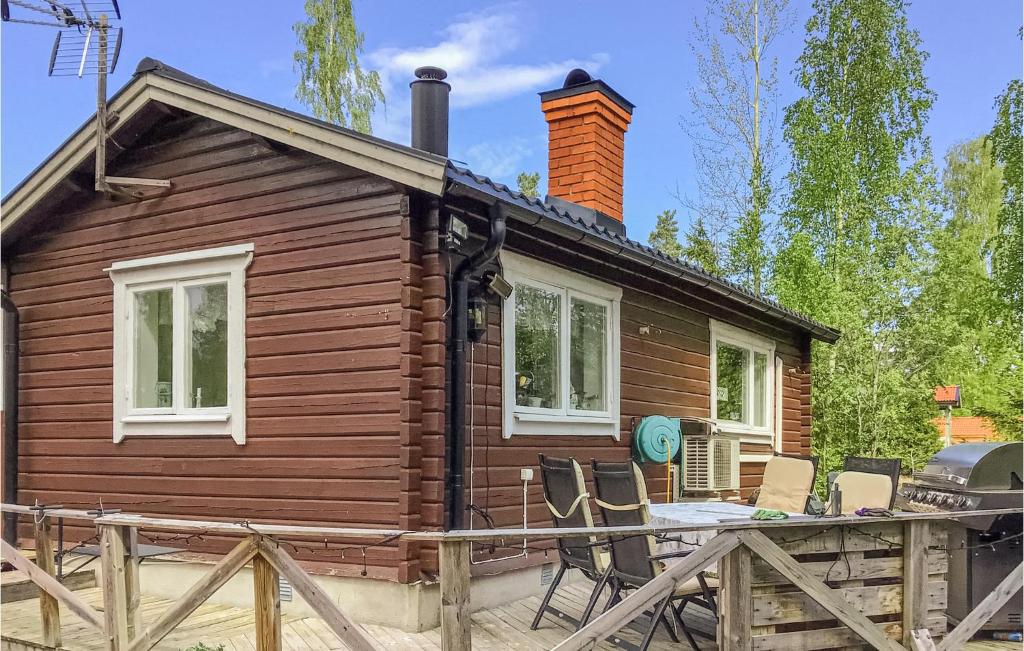 a small wooden house with chairs in front of it at Stunning Home In Gvle With Wifi And 1 Bedrooms in Gävle