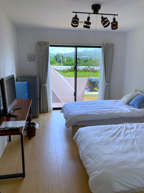 Postel nebo postele na pokoji v ubytování Nakijin Resort Guest House