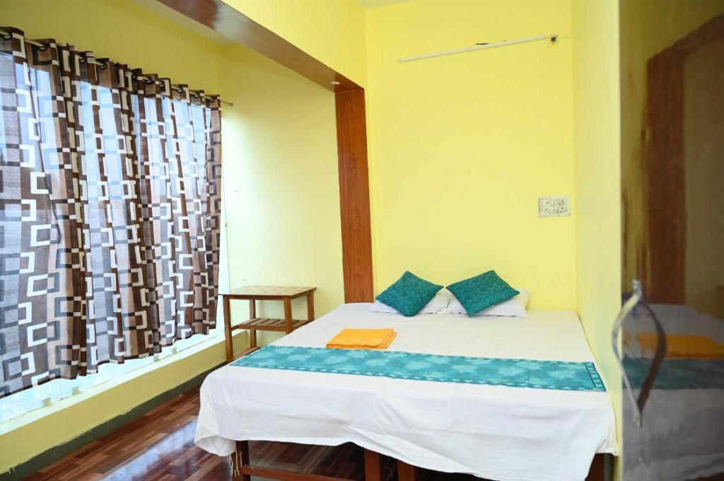 een slaapkamer met een bed en een raam bij OYO Hotel River in Bhilai