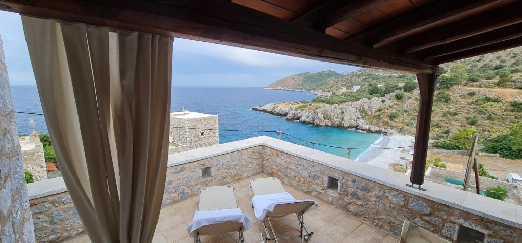 a balcony with chairs and a view of the ocean at Amazing View in Kokkala