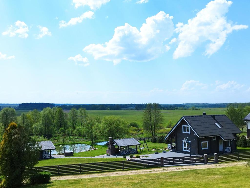 an aerial view of a black house with a yard at GREY PINE HOUSE in Druskininkai