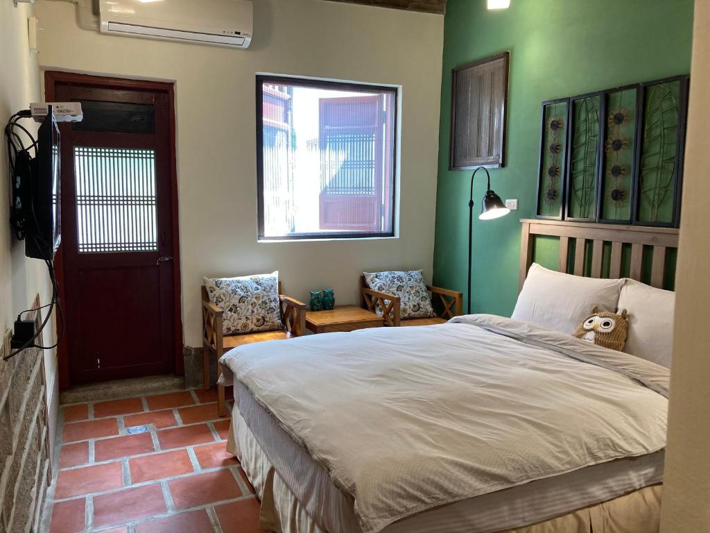 a bedroom with a bed with a teddy bear sitting on it at Shenten Homestay in Jincheng