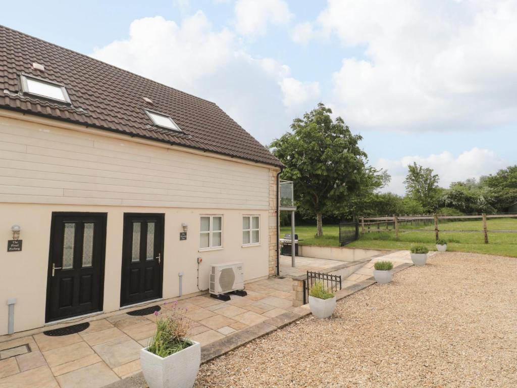 a house with black doors and a courtyard at The Final Furlong in Bruton