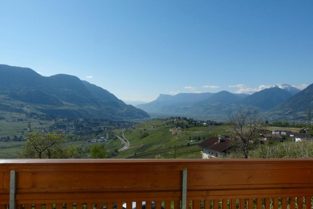 a view of a valley from a wooden fence at Garni Sonnleiten in Tirolo