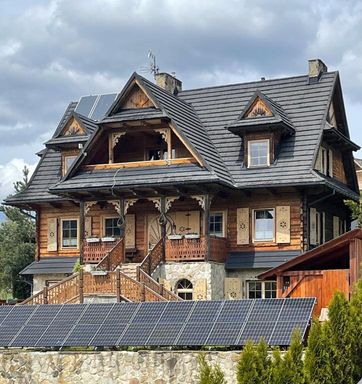 a house with solar panels in front of it at Willa Zawadówka in Szczawnica