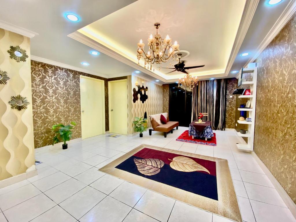 a large living room with a chandelier at Putravilla Condominium Lovely & Spacious with Public Pool in Kampong Kerdas