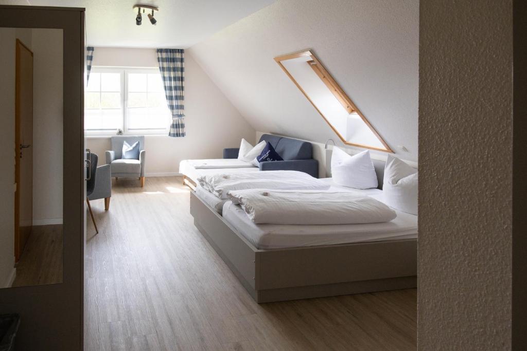 a bedroom with two beds in a attic at Gästehaus Kölfhamm 2 in Sankt Peter-Ording
