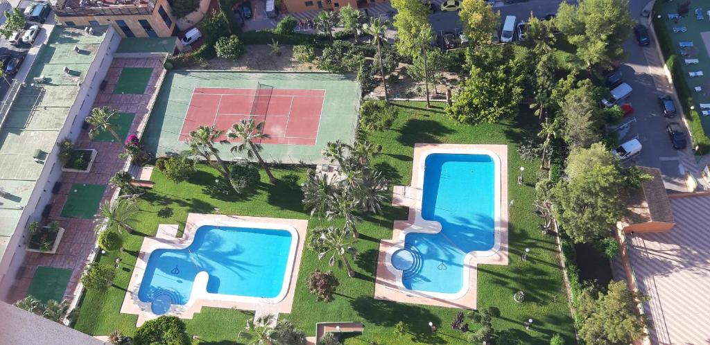 an overhead view of two swimming pools in a yard at Apartamento Gemelos XII -23 in Benidorm
