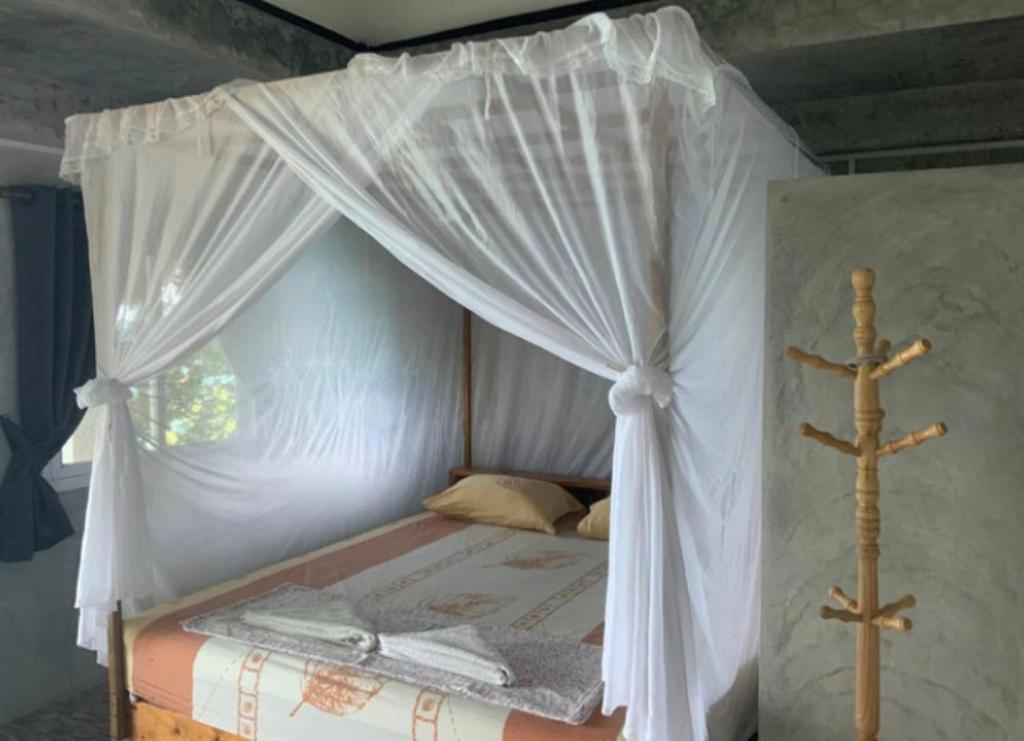 Postel nebo postele na pokoji v ubytování Tao Thong Villa 1