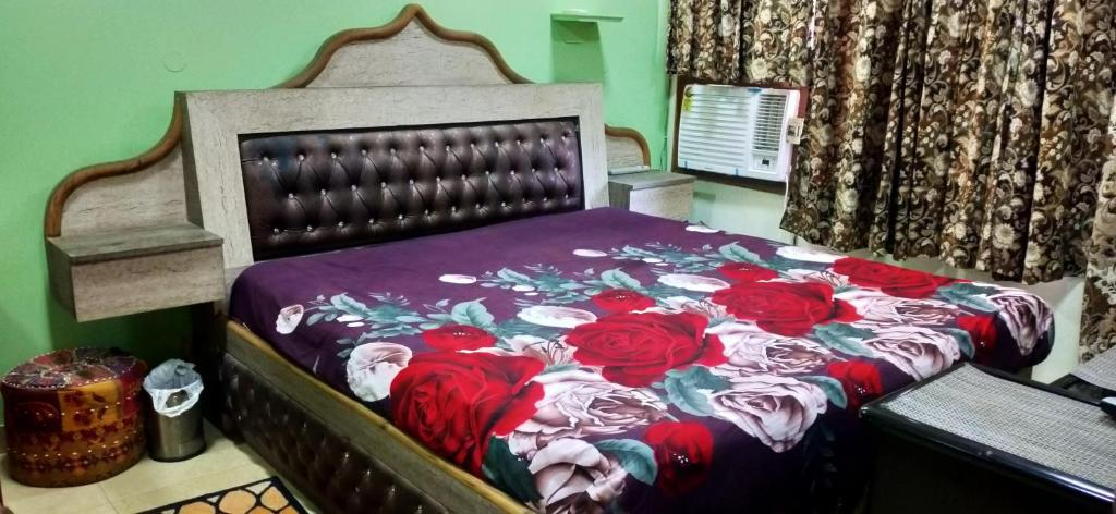 a bedroom with a bed with red roses on it at Trehan's Residence in New Delhi