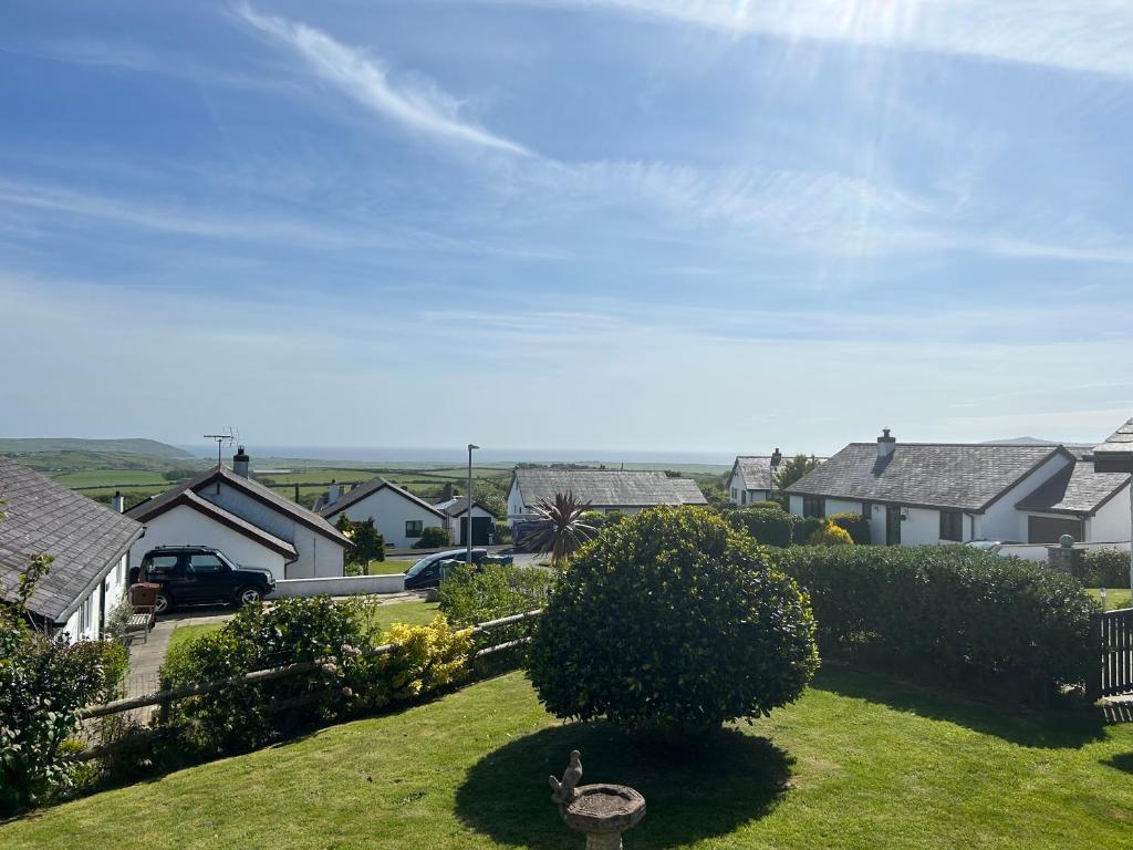 a house with a bird sitting on the grass at Idyllic holiday near Abersoch in Mynytho