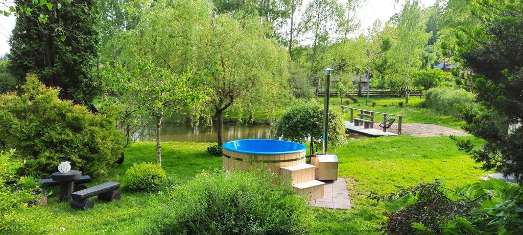 a hot tub in the middle of a park at Klimatyczny domek blisko natury na Podlasiu - Wysokie Laski 9! in Sokółka