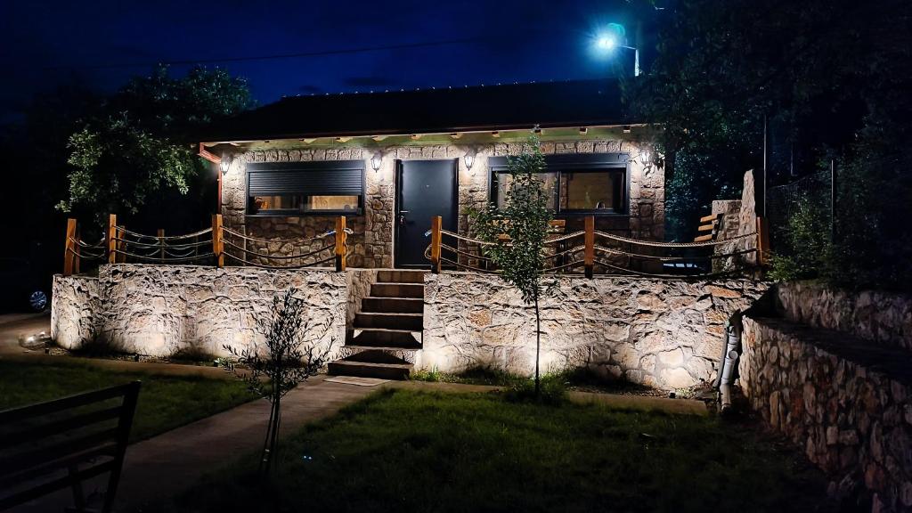 a stone house at night with a stone wall at Stone House Montenegro in Danilovgrad