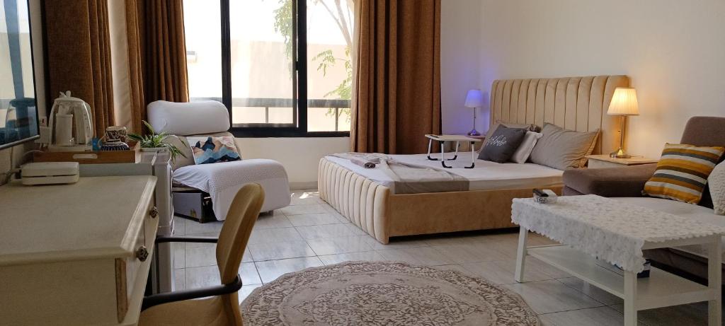 a hotel room with a bed and a living room at Jumeirah Beach Villa in Dubai