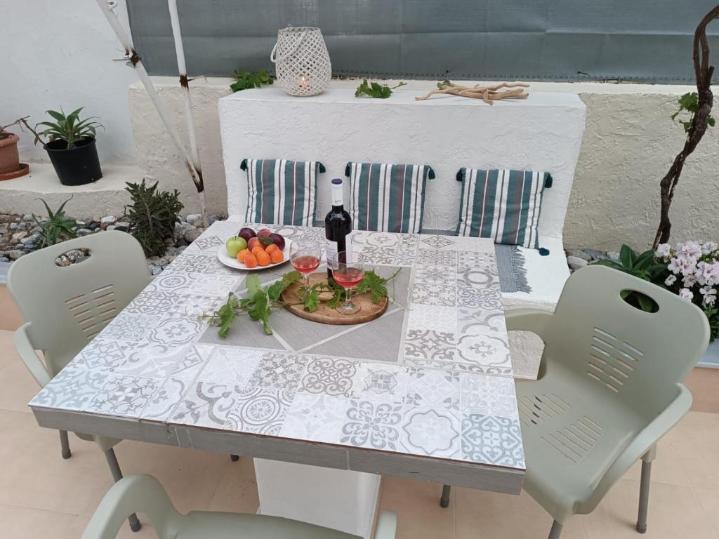 卡林諾斯的住宿－Kalymnos residence，一张桌子,上面放着一盘水果和一瓶葡萄酒