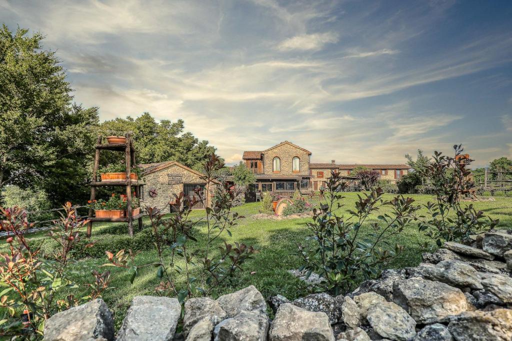 a large house with a garden in front of it at Ca' del Monte Resort in Serra del Monte