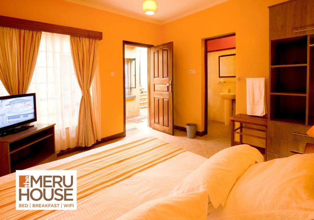 Ένα ή περισσότερα κρεβάτια σε δωμάτιο στο The Meru House