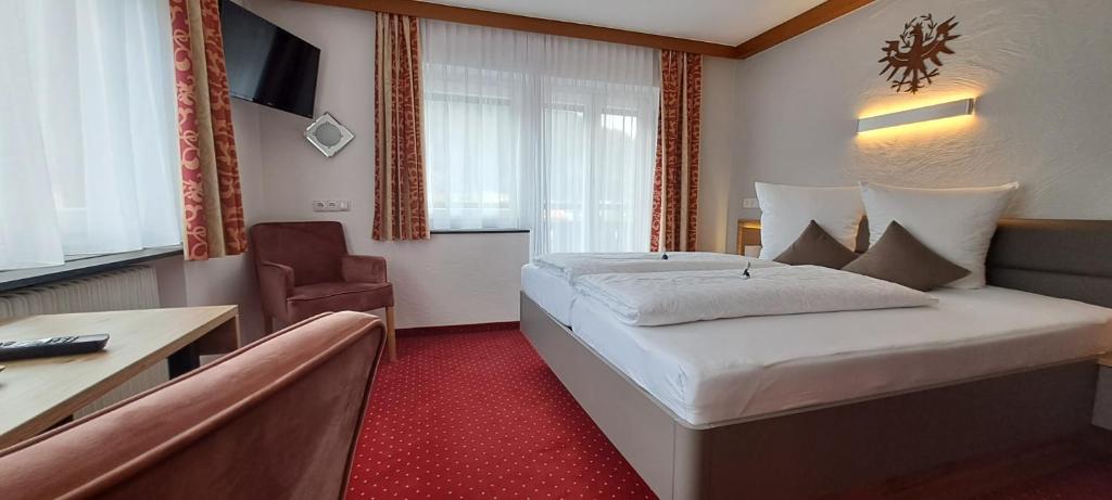 Postel nebo postele na pokoji v ubytování Haus Tirol Appartements