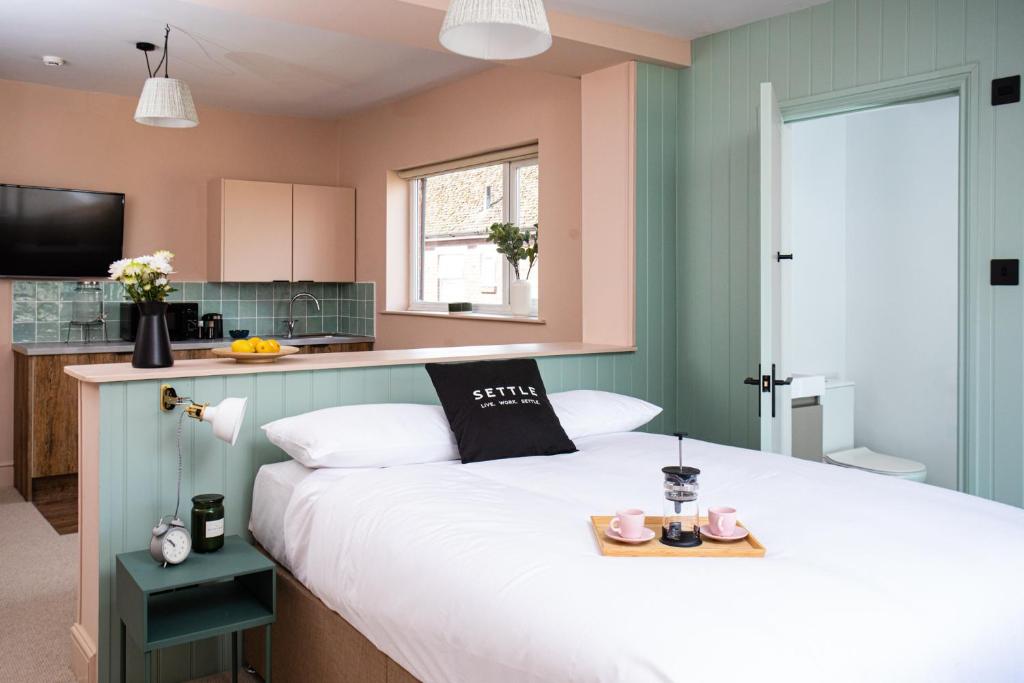 a bedroom with a bed with a tray on it at Settle in Southampton in Southampton