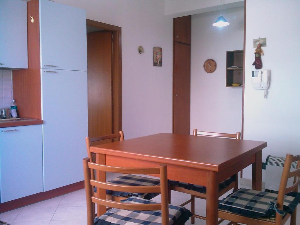 a kitchen with a table and chairs and a refrigerator at Casaditony in Trapani